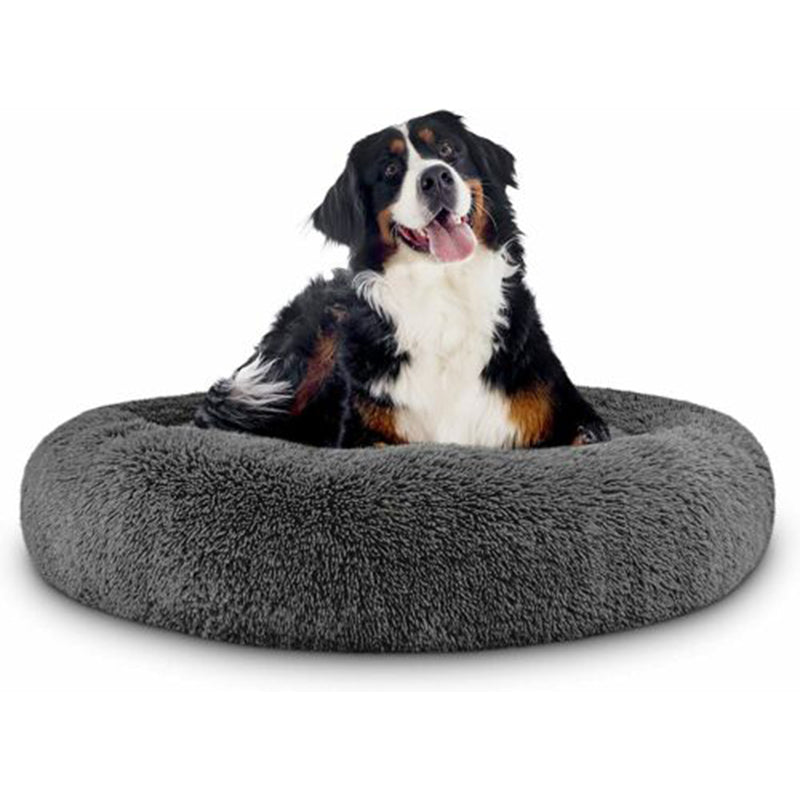 Dog relaxing in a plush grey bed
